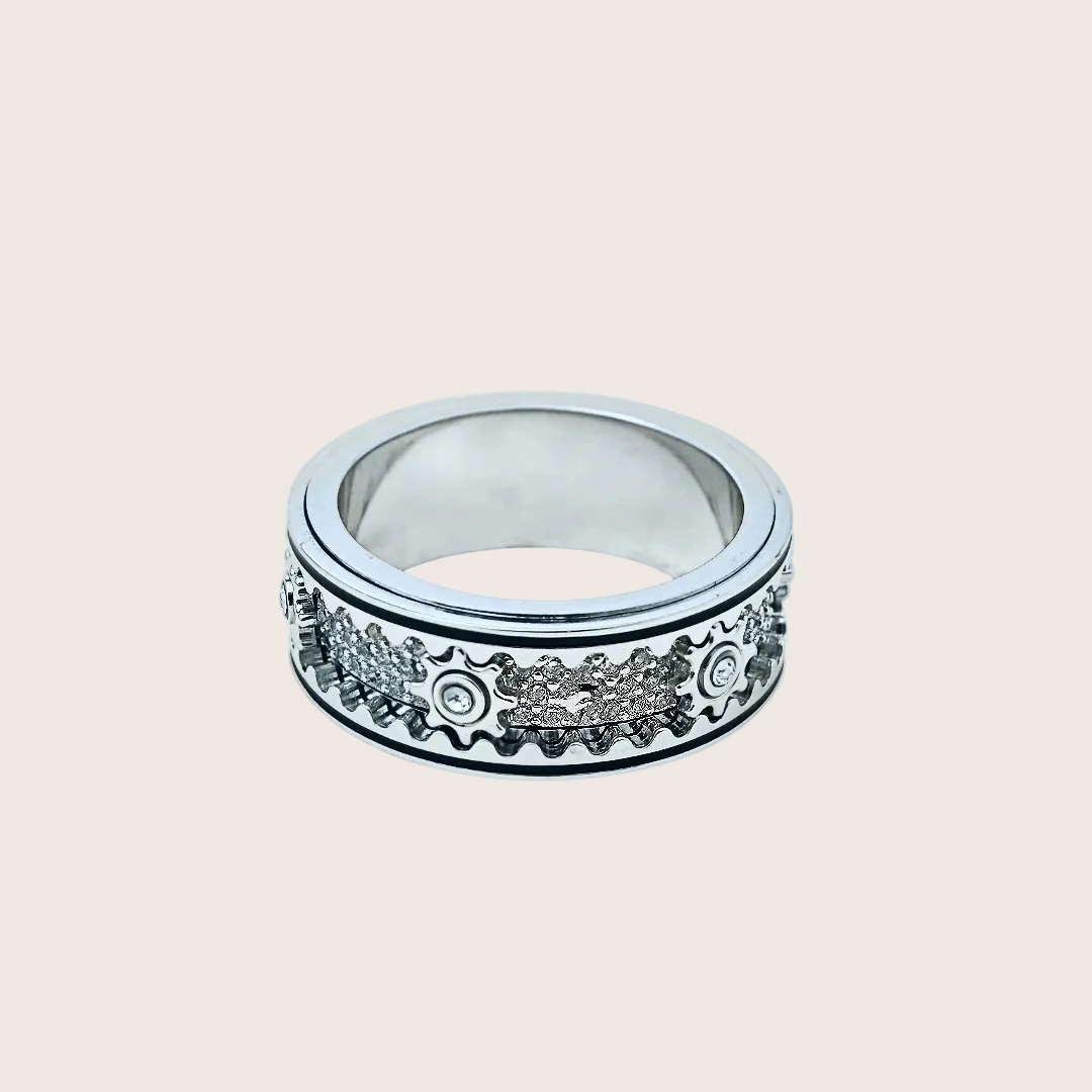 Silver ring with decorative design on a white background