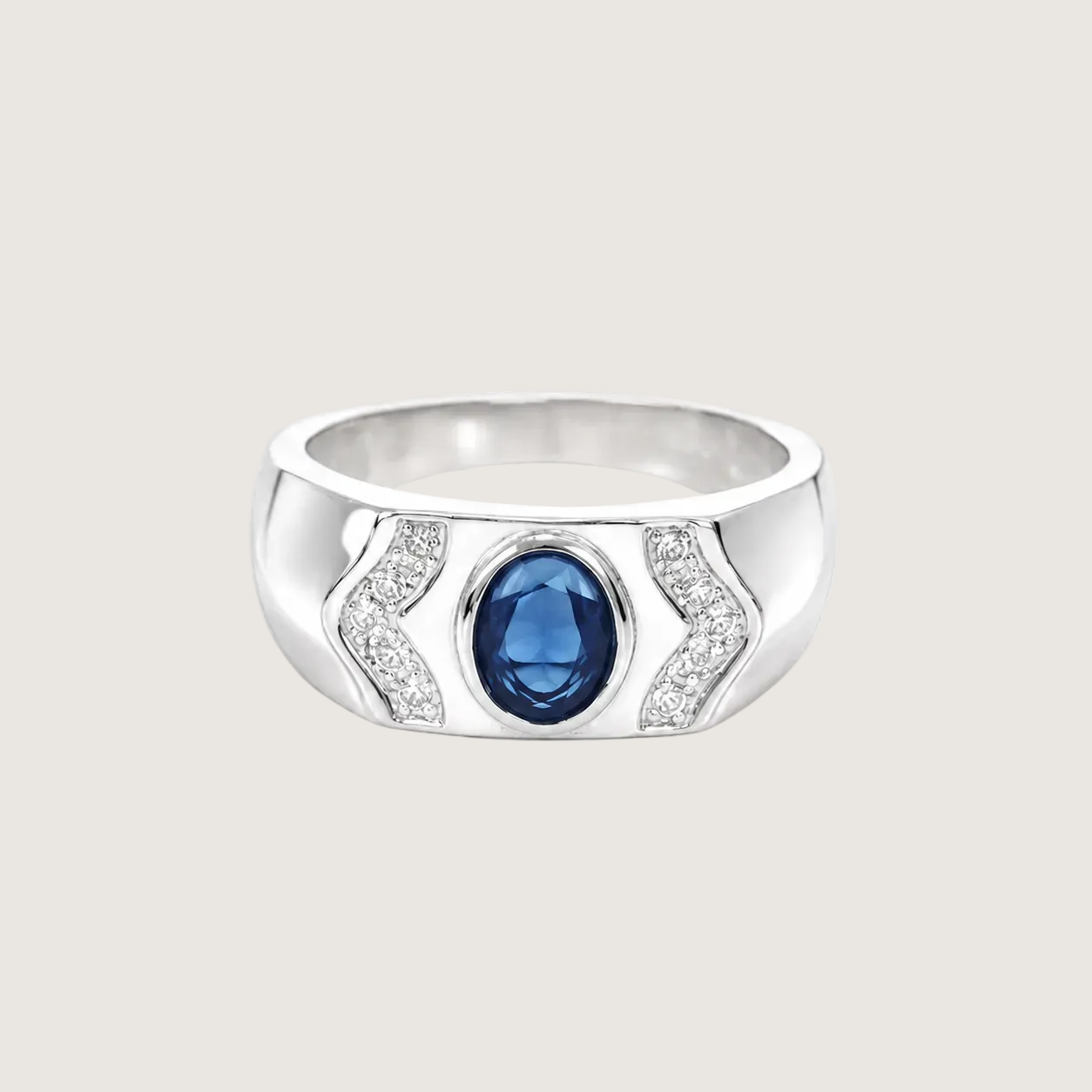 Silver ring with a blue gemstone on a light beige background