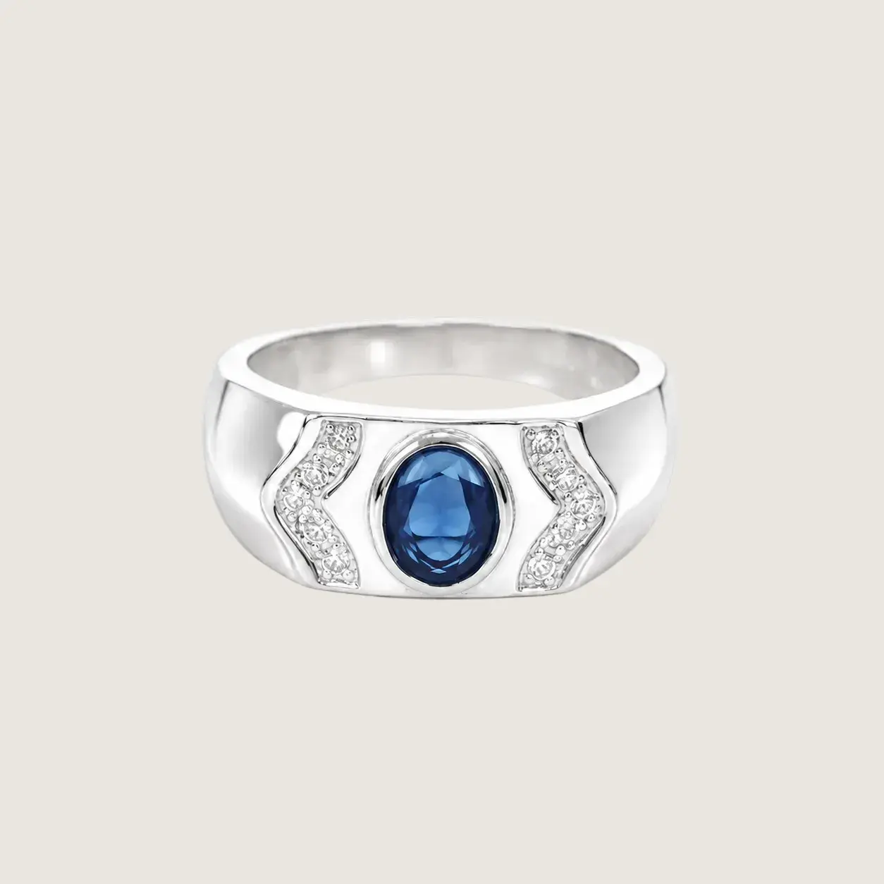 Silver ring with a blue gemstone on a light beige background