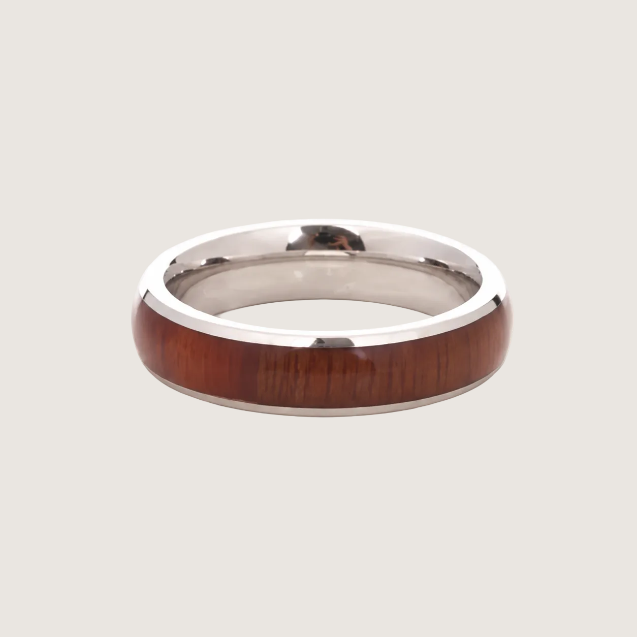Silver ring with a wooden inlay on a light gray background