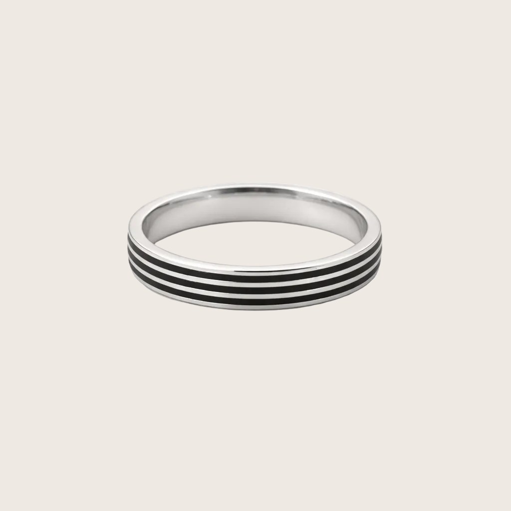 Silver ring with black stripes on a white background