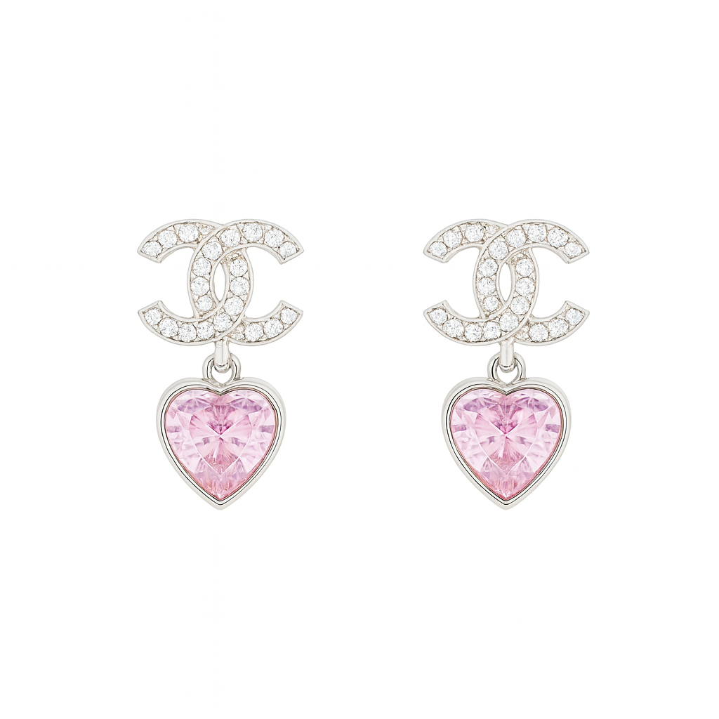 Chanel earrings with pink heart charms on a white background