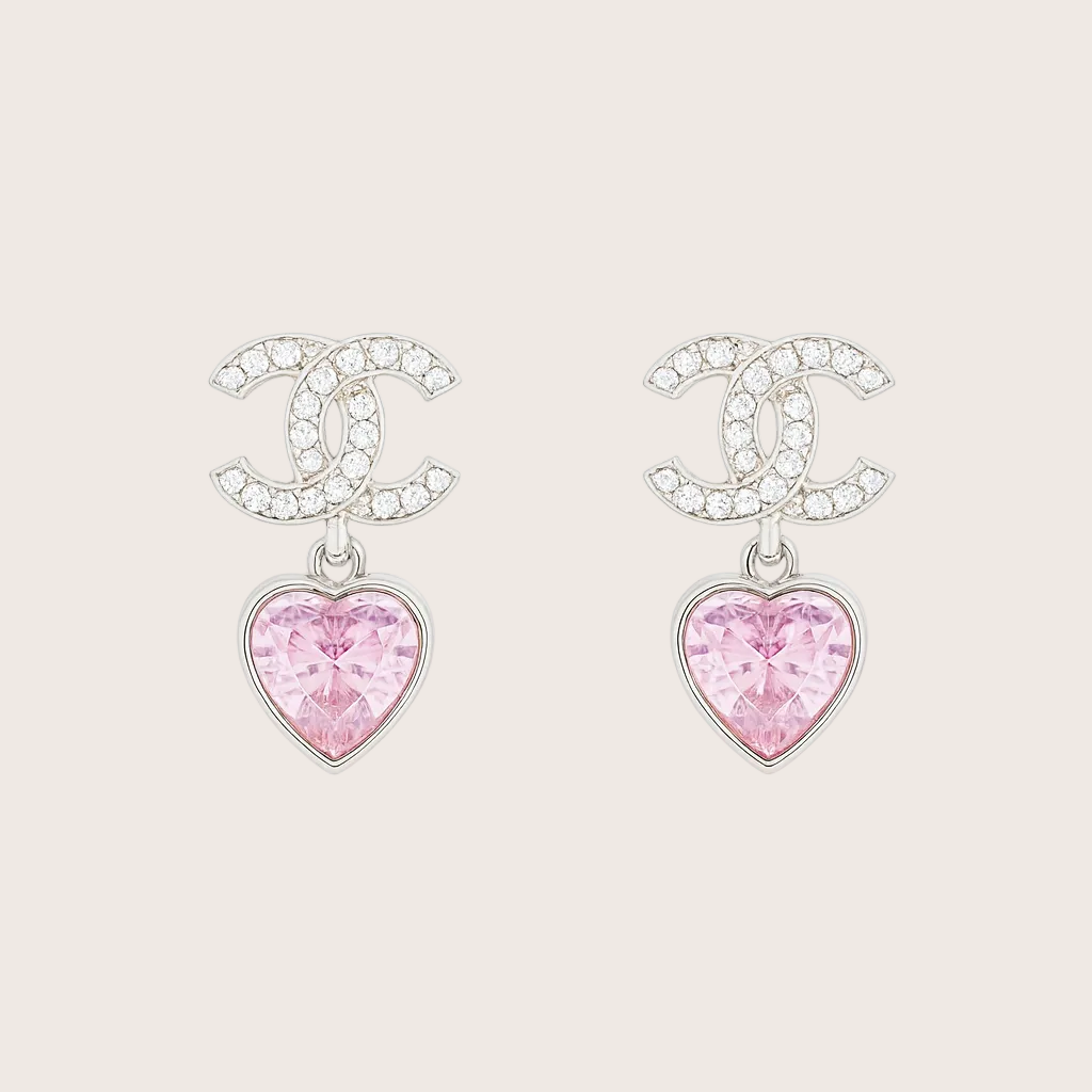 Chanel earrings with pink heart charms on a white background