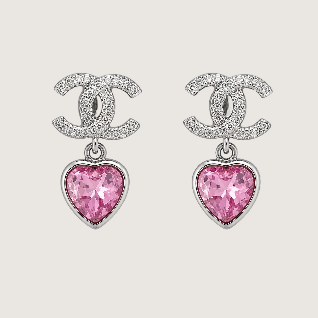 Chanel earrings with pink heart-shaped gemstones on a light gray background