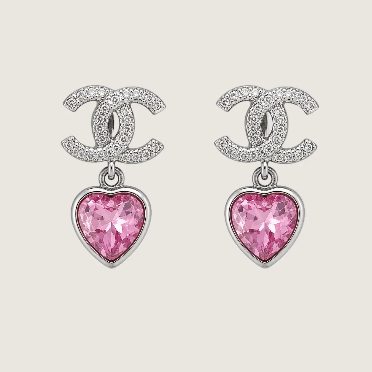 Chanel earrings with pink heart-shaped gemstones on a light gray background