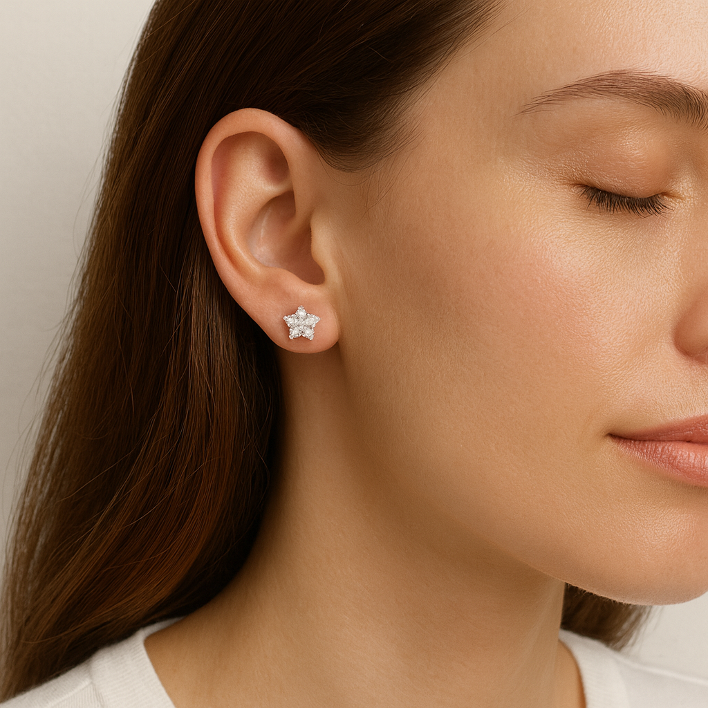 Close-up of a woman wearing diamond stud earrings with a neutral background