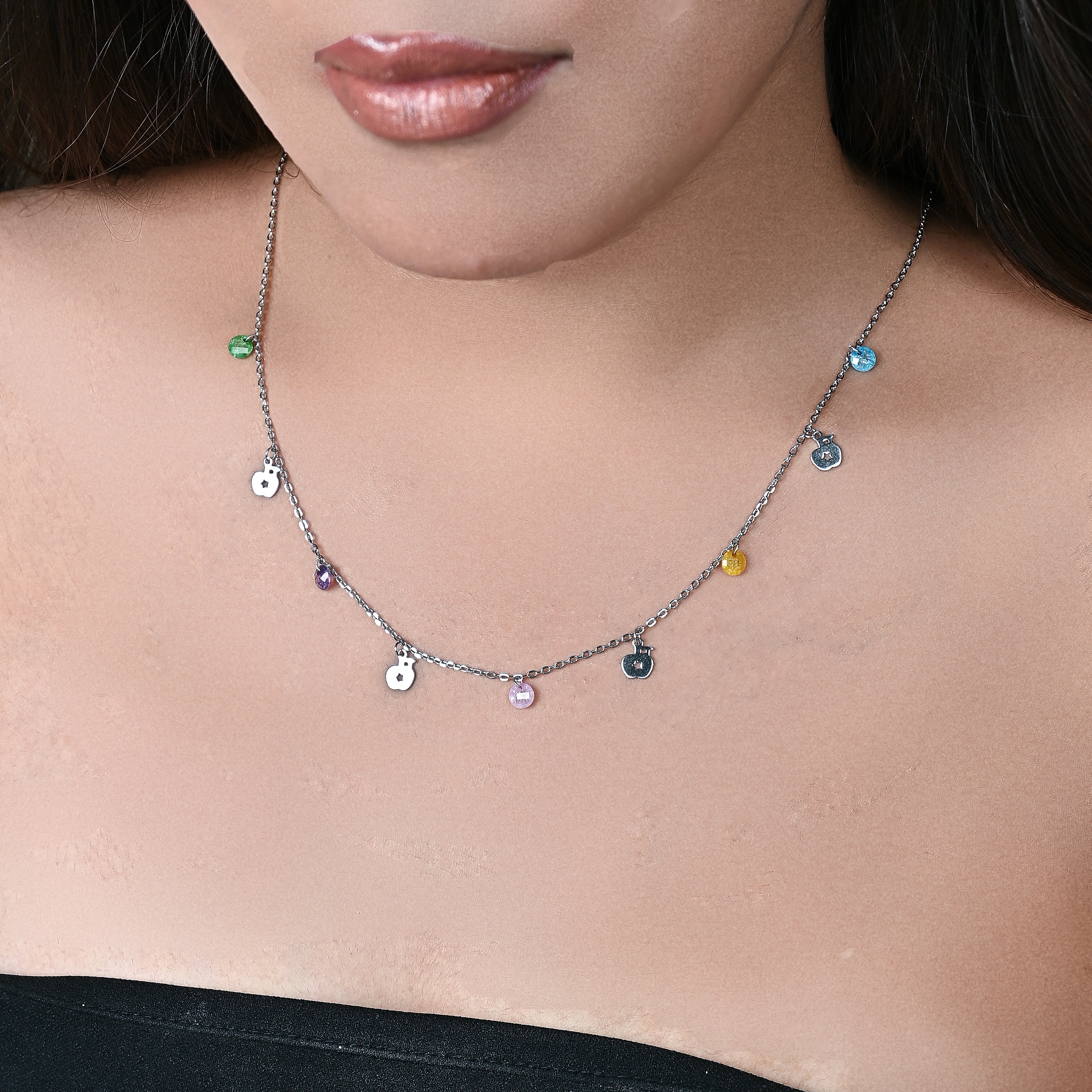 Necklace with colorful beads worn by a person, brand 'Trishna' visible