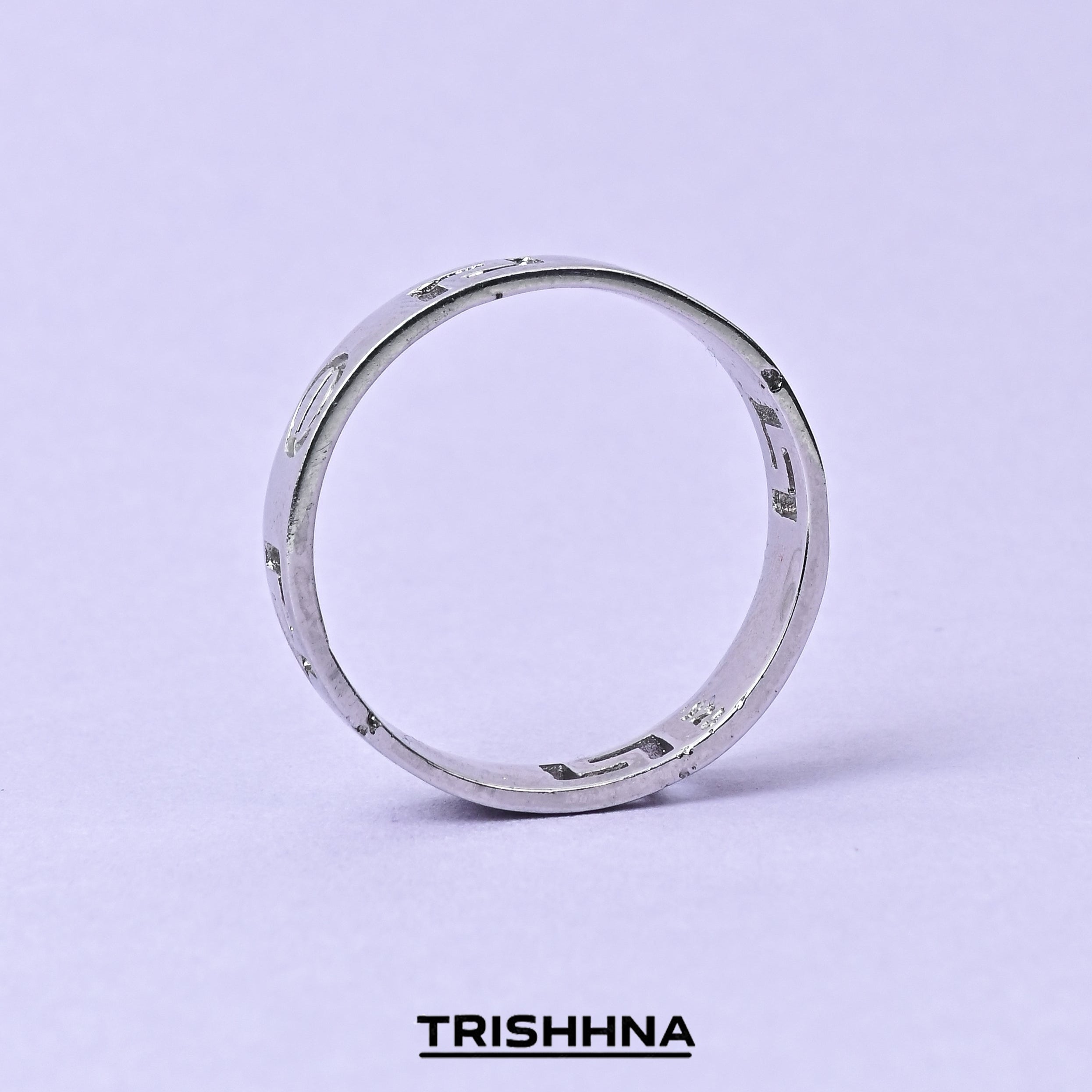 Silver ring on a light purple background with 'TRISHNHA' branding.
