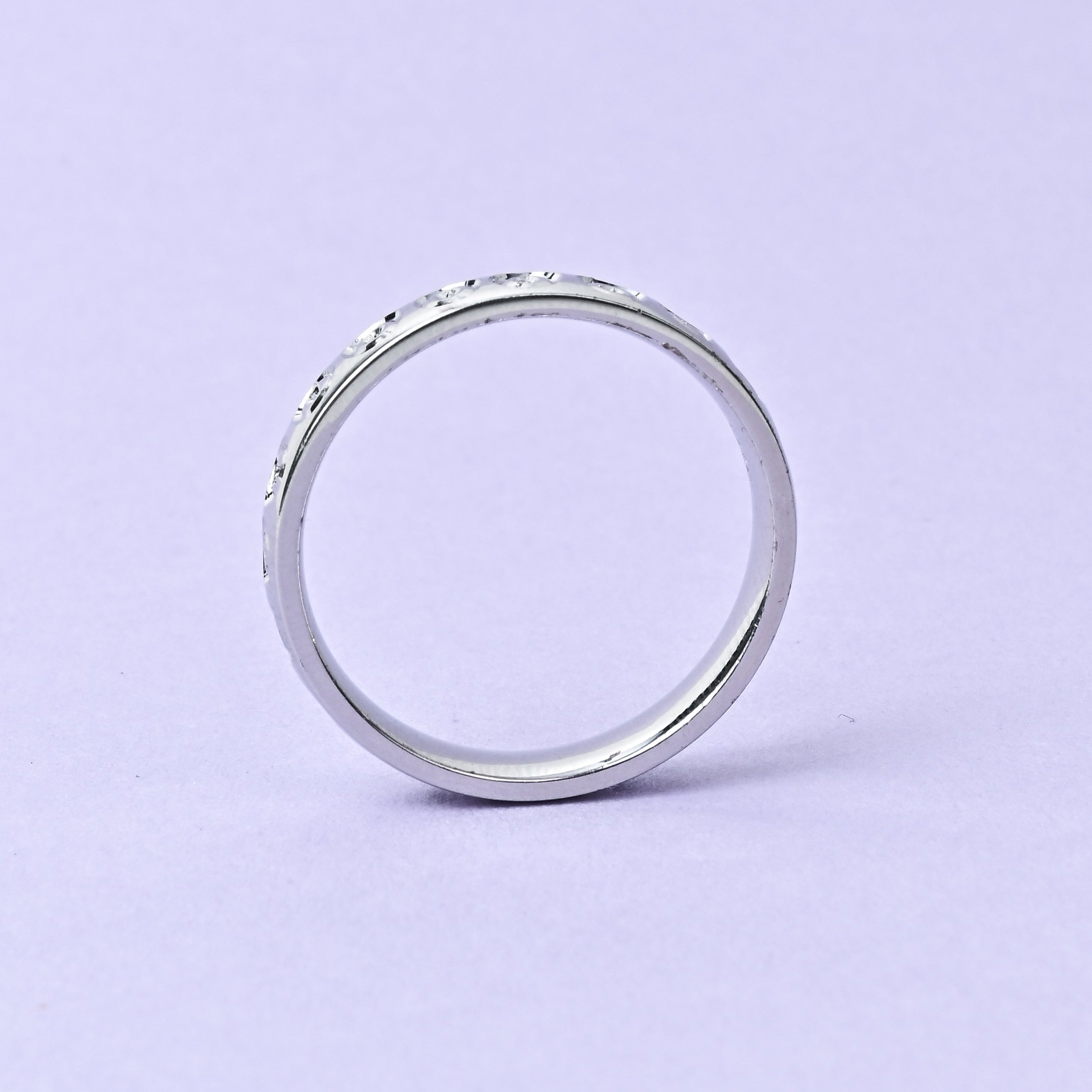 Silver ring on a light purple background with 'TRISHNHA' branding.