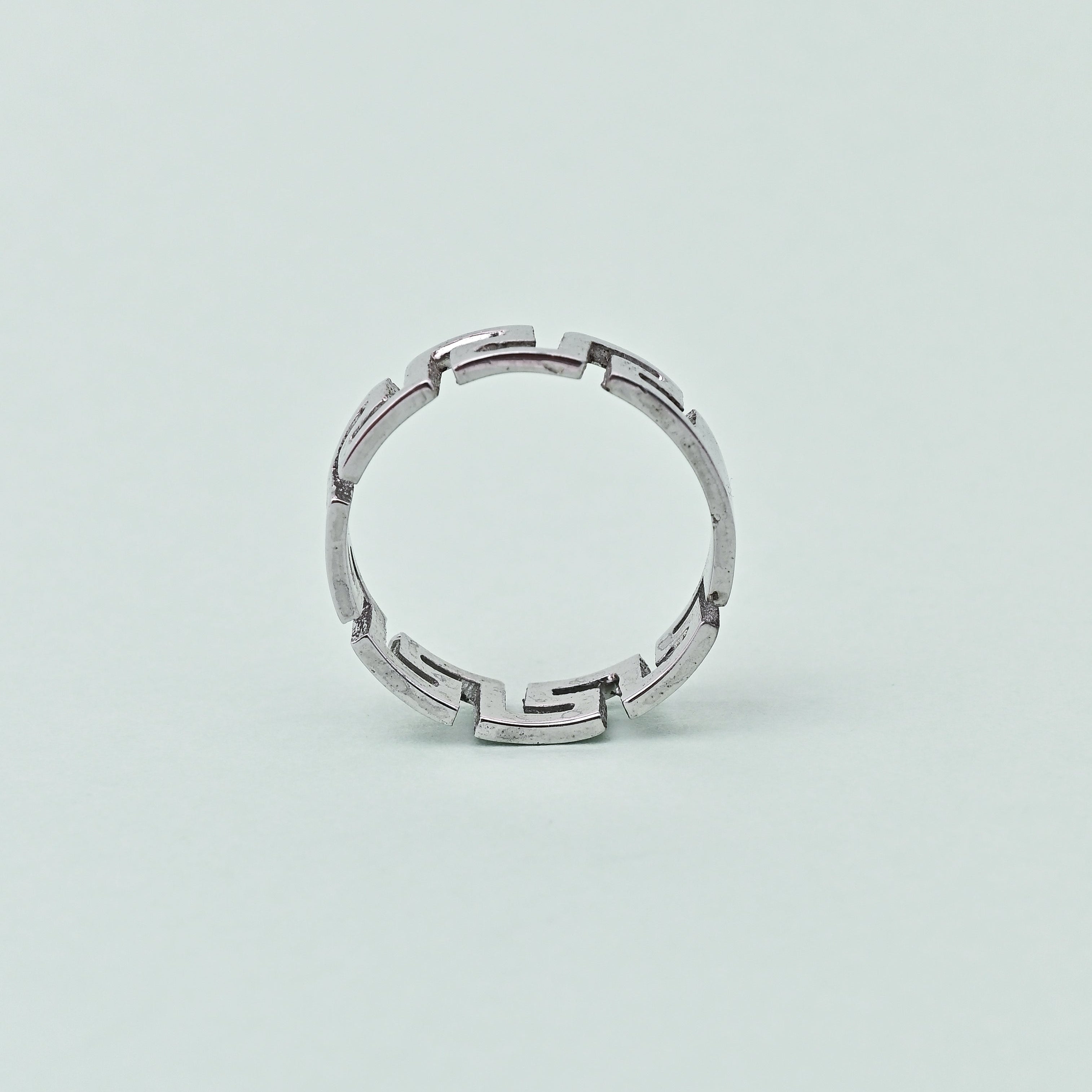 Silver ring on a light gray background with 'TRISHNHA' branding.