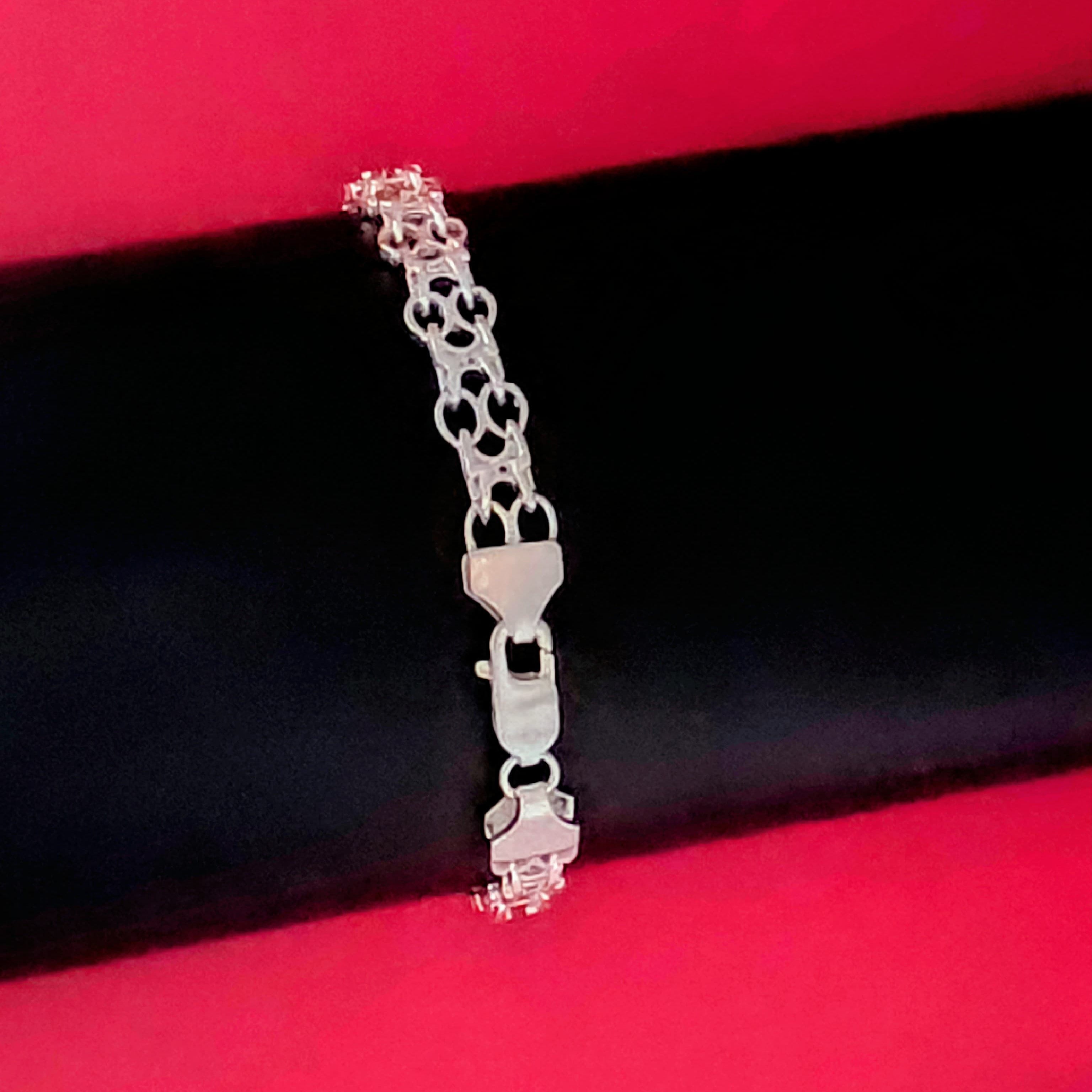 Silver bracelet on a red and black background