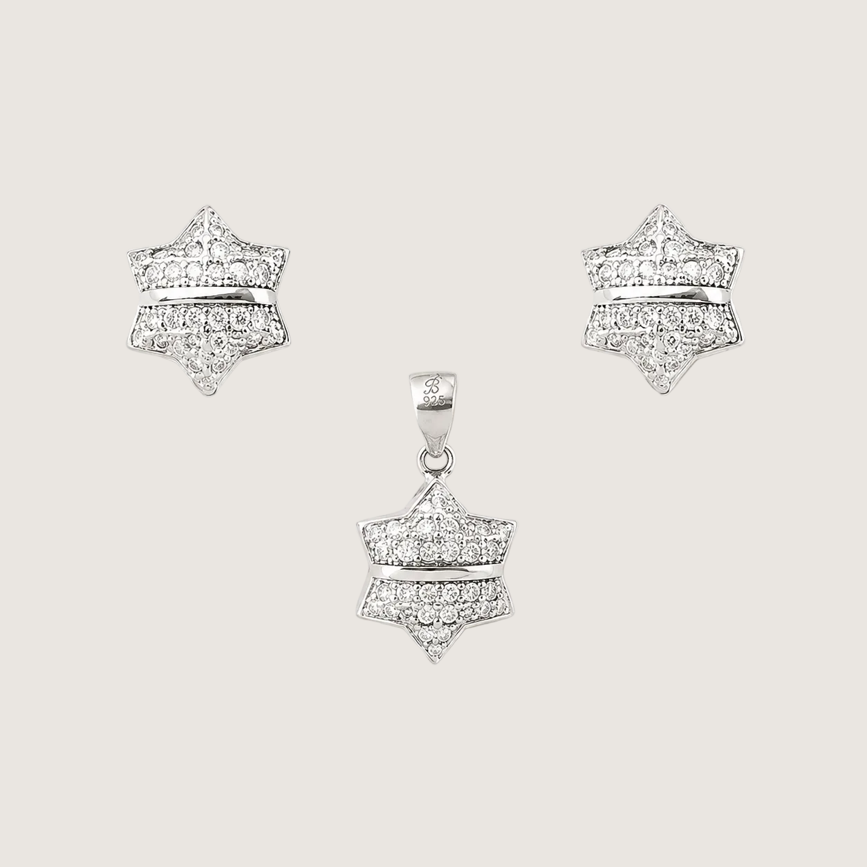 Star-shaped diamond earrings on a light gray background