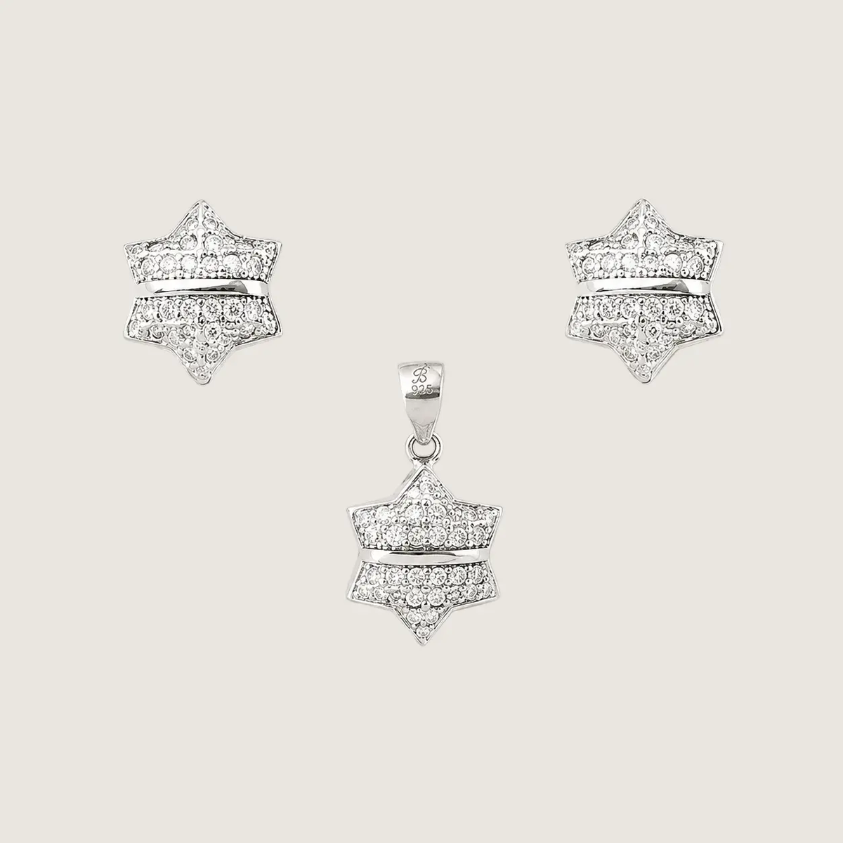 Star-shaped diamond earrings on a light gray background