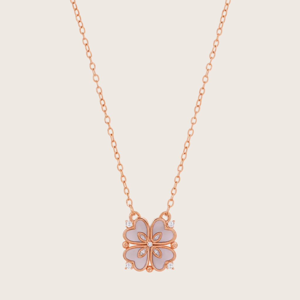 Rose gold necklace with a floral pendant on a white background