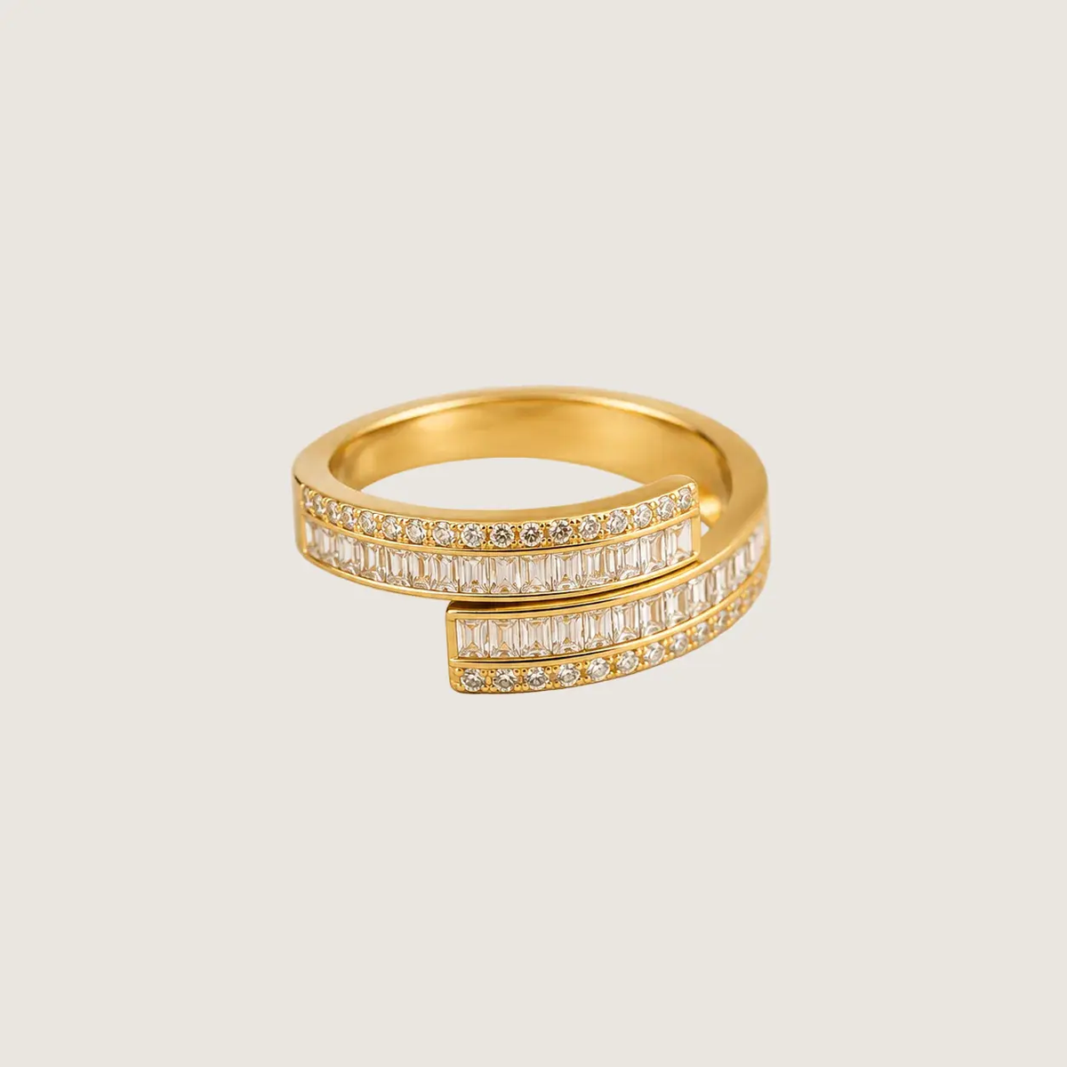 Gold ring with diamond accents on a beige background
