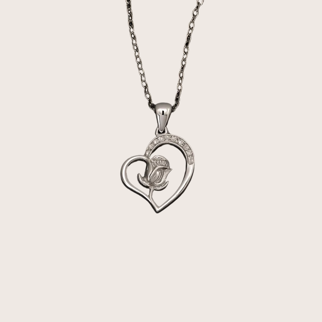Silver heart-shaped pendant with a rose design on a black background