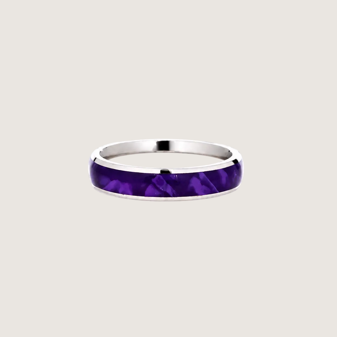 Silver ring with a purple inlay on a light gray background