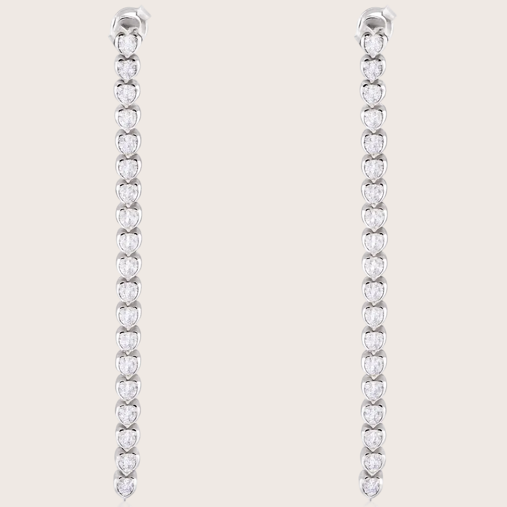 Pair of silver earrings with clear stones on a white background