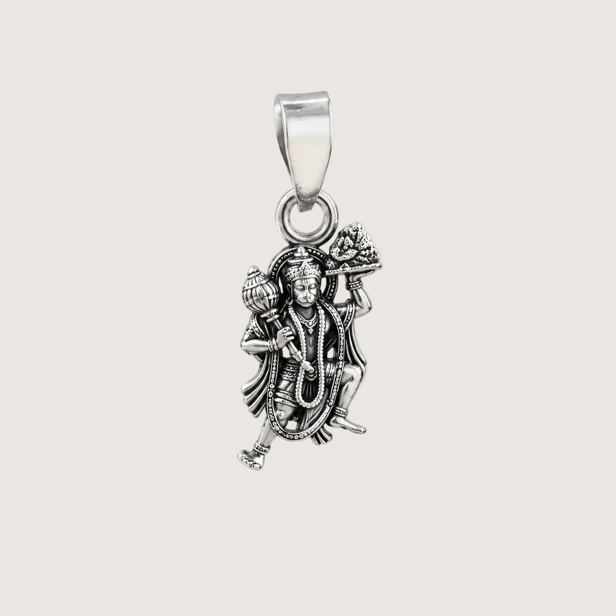 Silver pendant with a deity figure on a light beige background