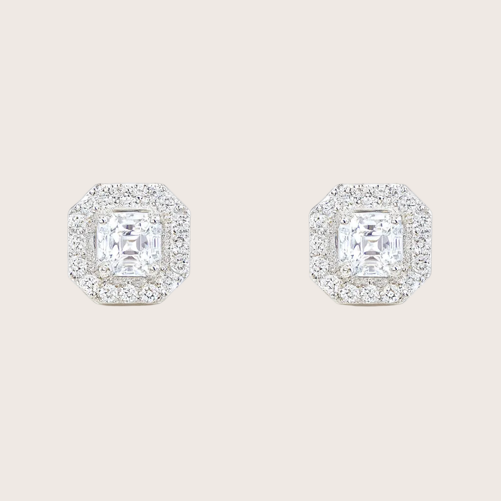 Pair of diamond stud earrings on a white background