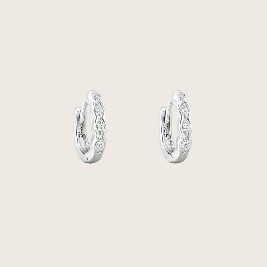 Pair of silver hoop earrings with small diamonds on a white background