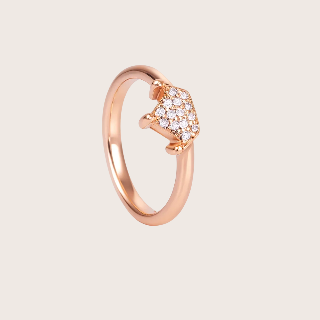 Rose gold ring with diamond accents on a white background