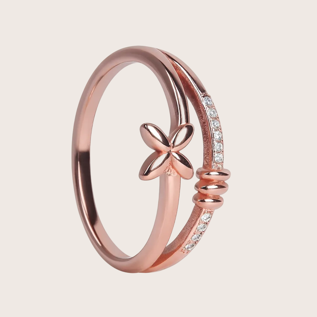 Rose gold ring with butterfly design and small diamonds on a white background