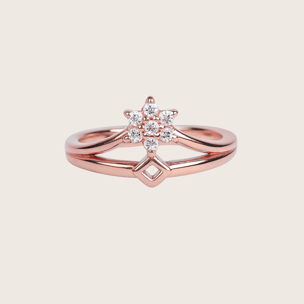 Rose gold ring with diamond accents on a white background