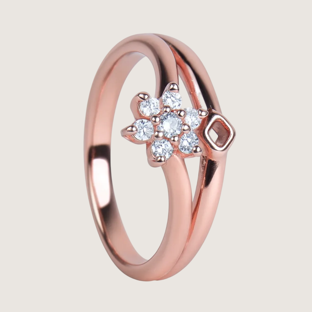 Rose gold ring with a floral design and diamonds on a white background