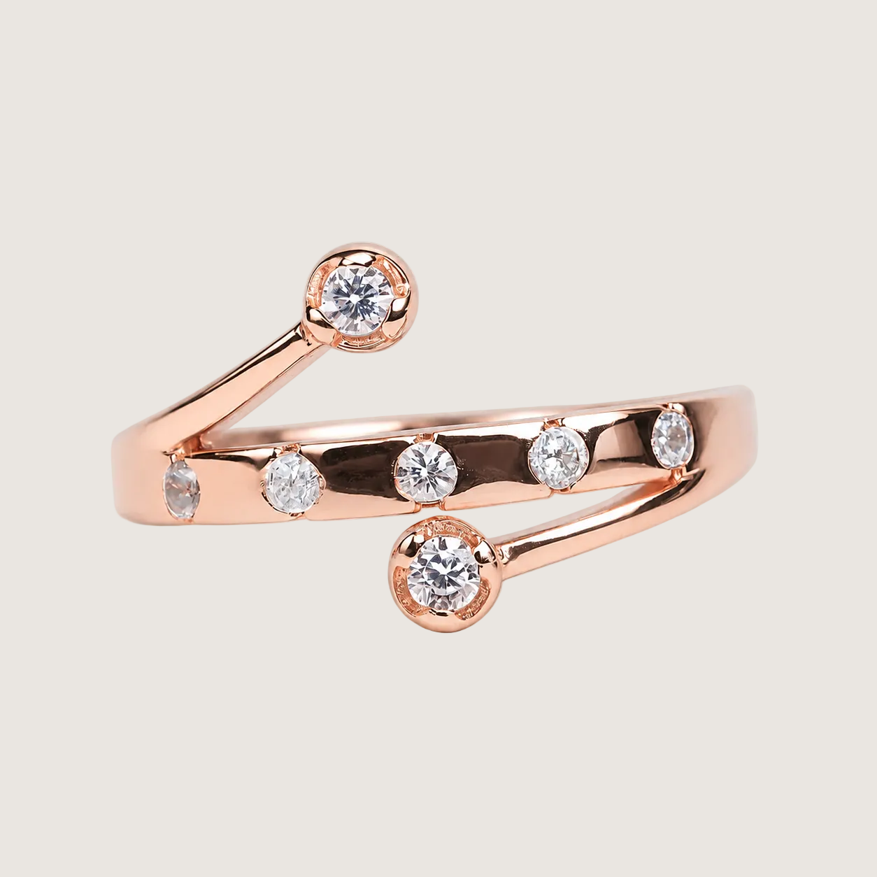 Rose gold ring with diamonds on a beige background