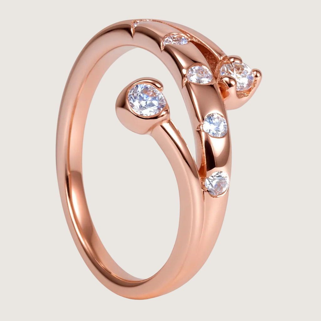 Rose gold ring with diamonds on a white background