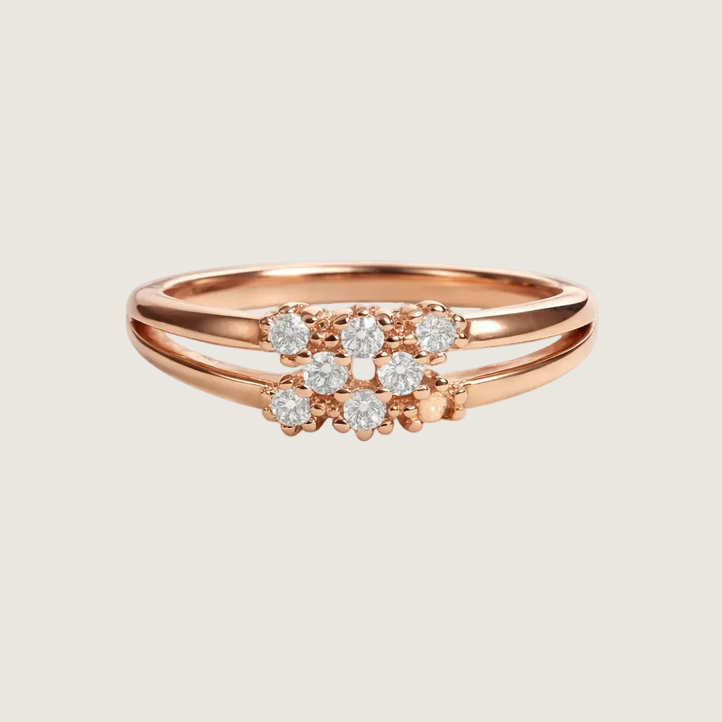 Rose gold ring with diamond cluster on a light beige background