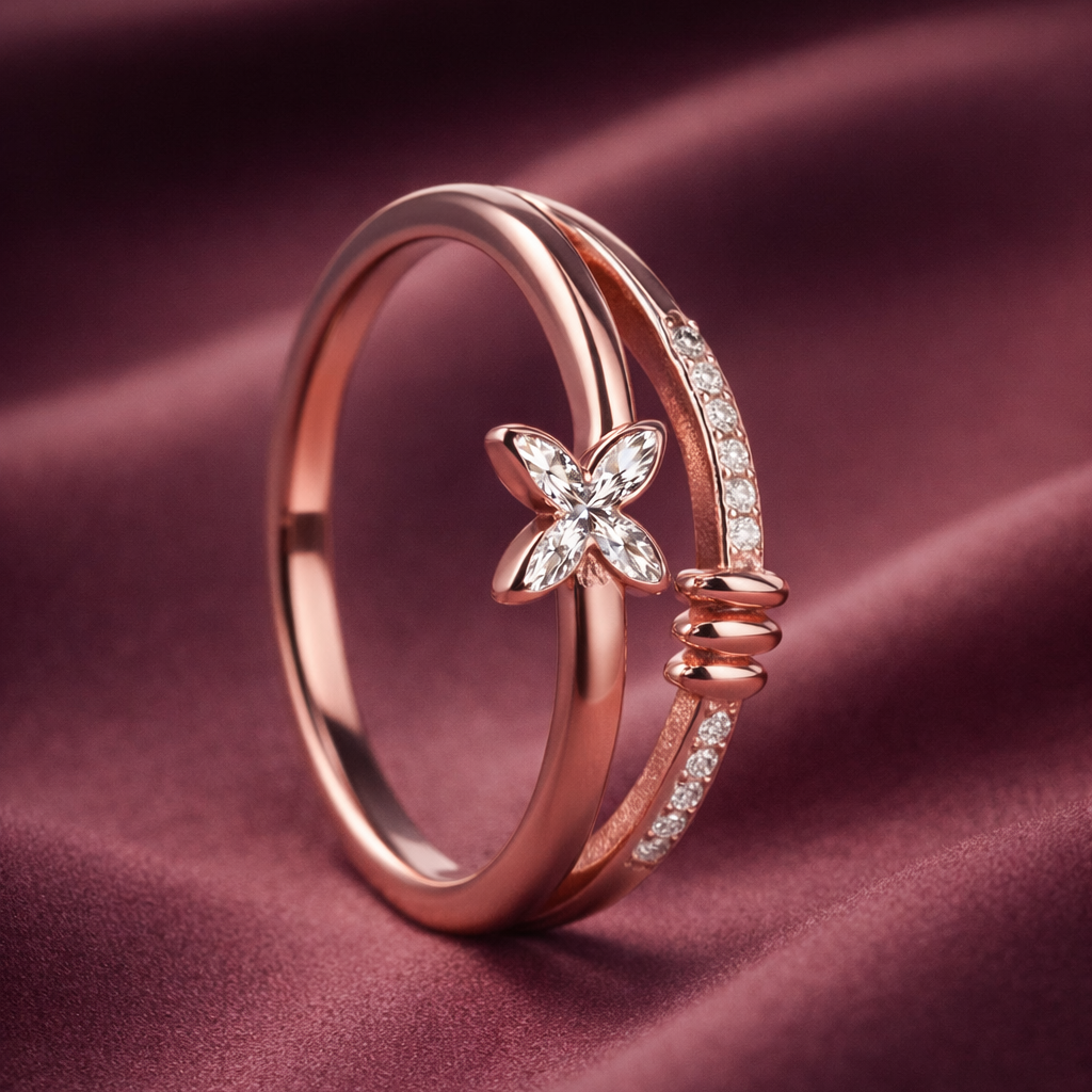 Rose gold ring with butterfly design on a maroon fabric background