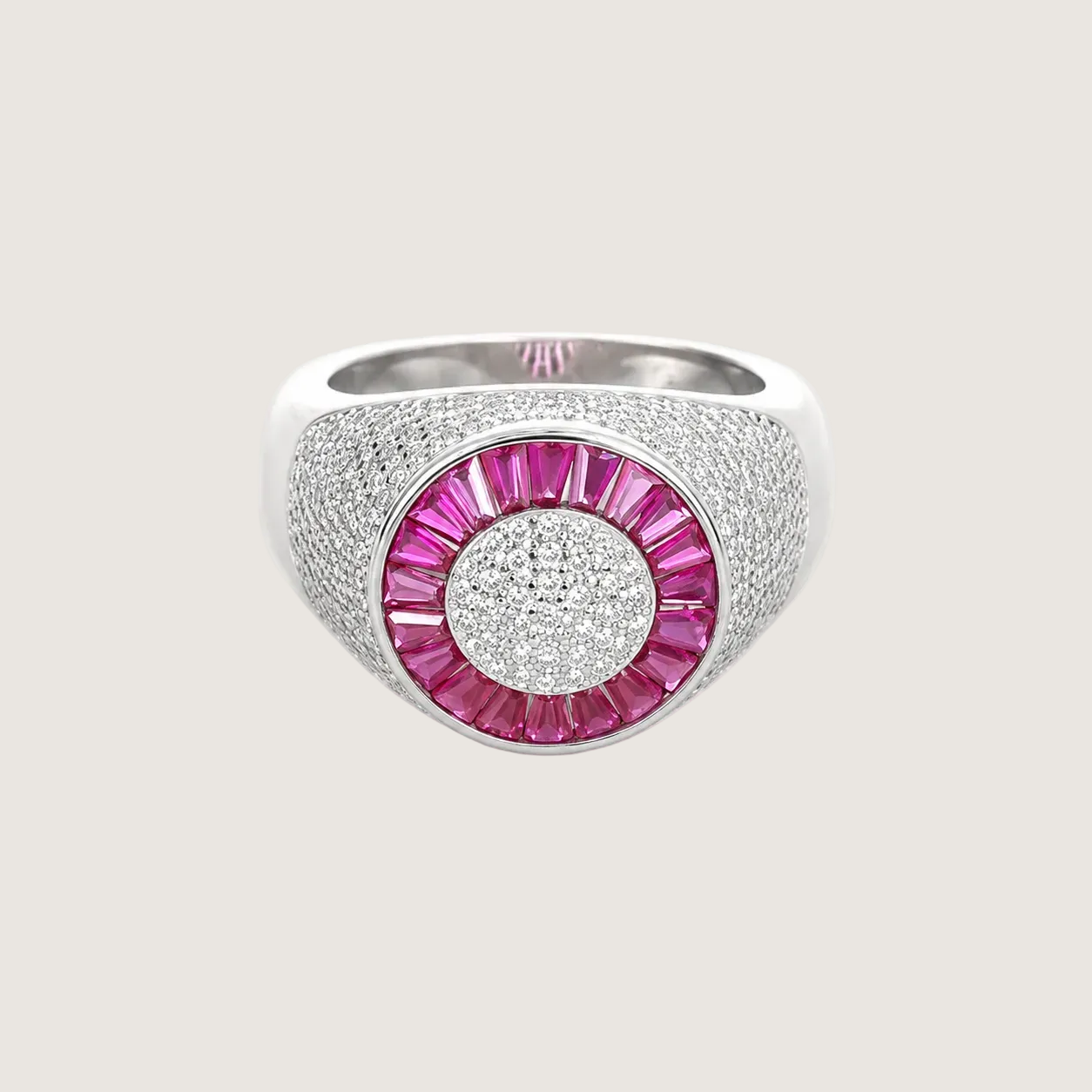 Silver ring with pink gemstone on a light beige background