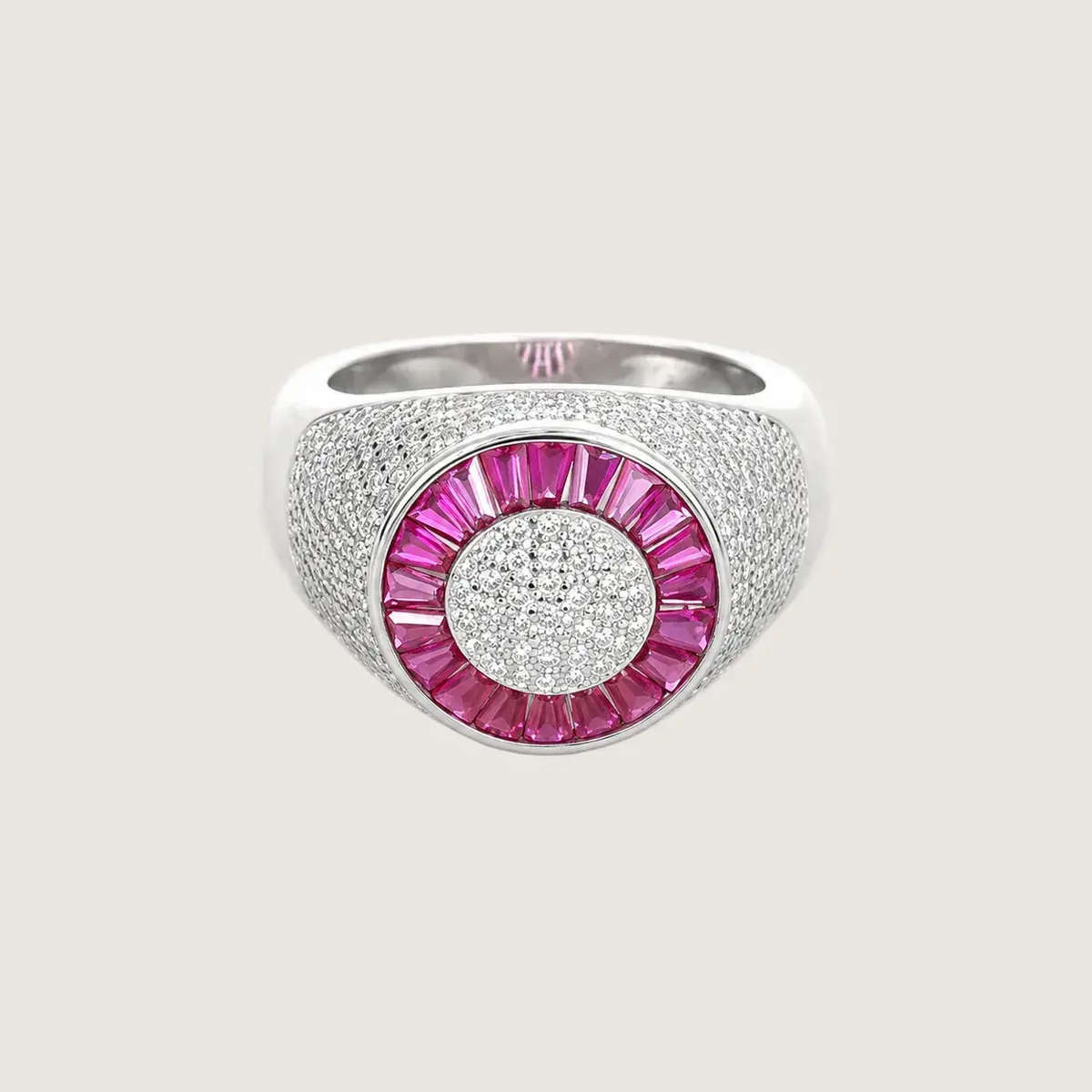 Silver ring with pink gemstone on a light beige background