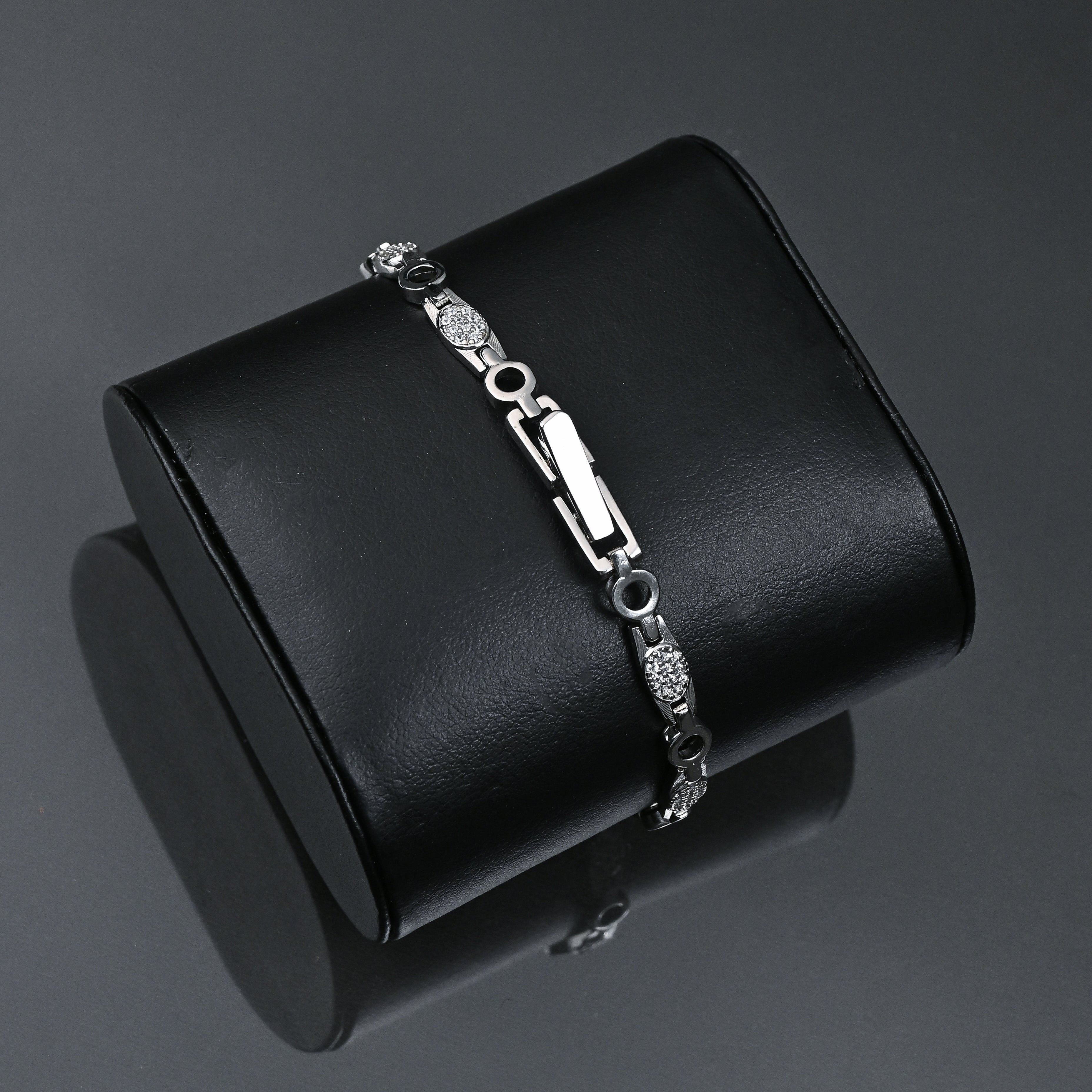 Silver bracelet on a black jewelry box with 'TRISHNHA' branding.