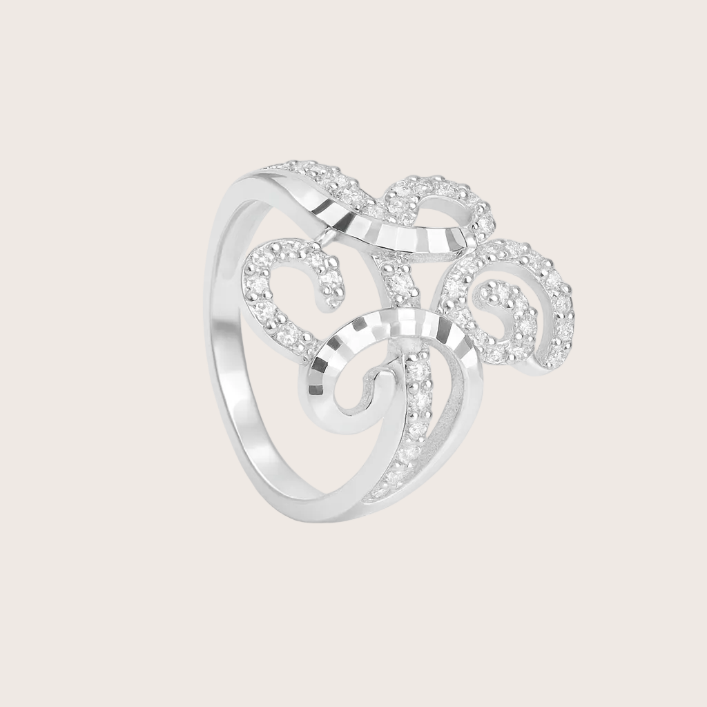 Silver ring with intricate design on a white background