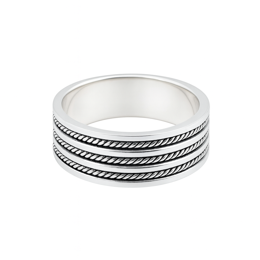 Stack of three silver rings with textured band design on a white background