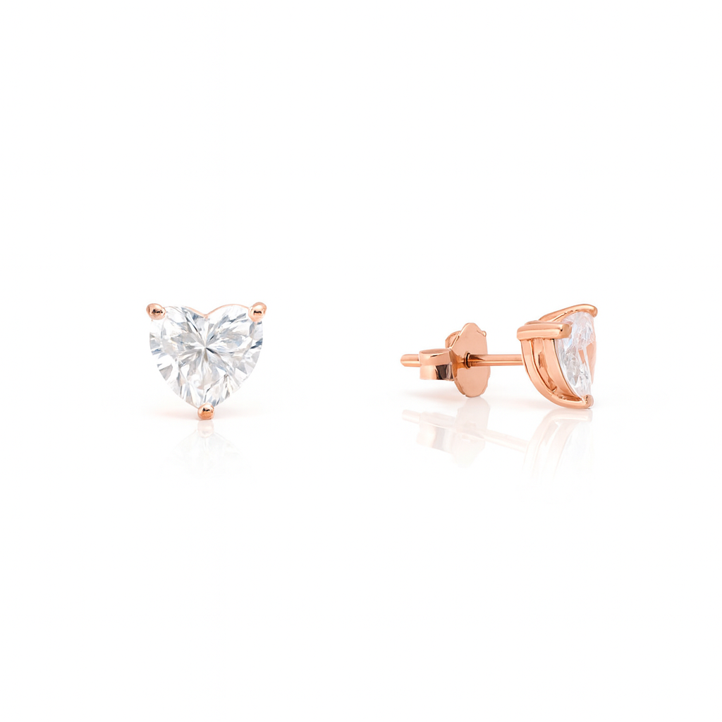 Rose gold heart-shaped stud earrings on a white background