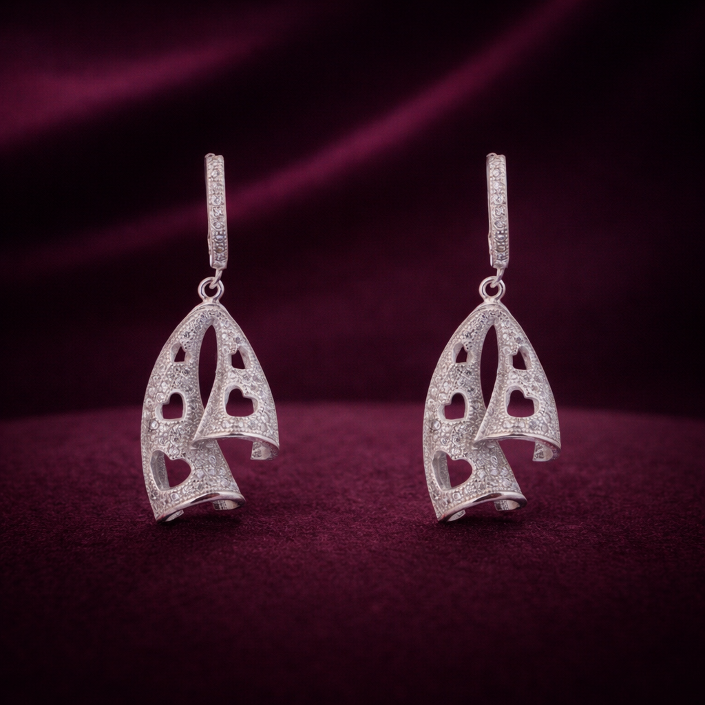 Pair of silver earrings on a dark red background
