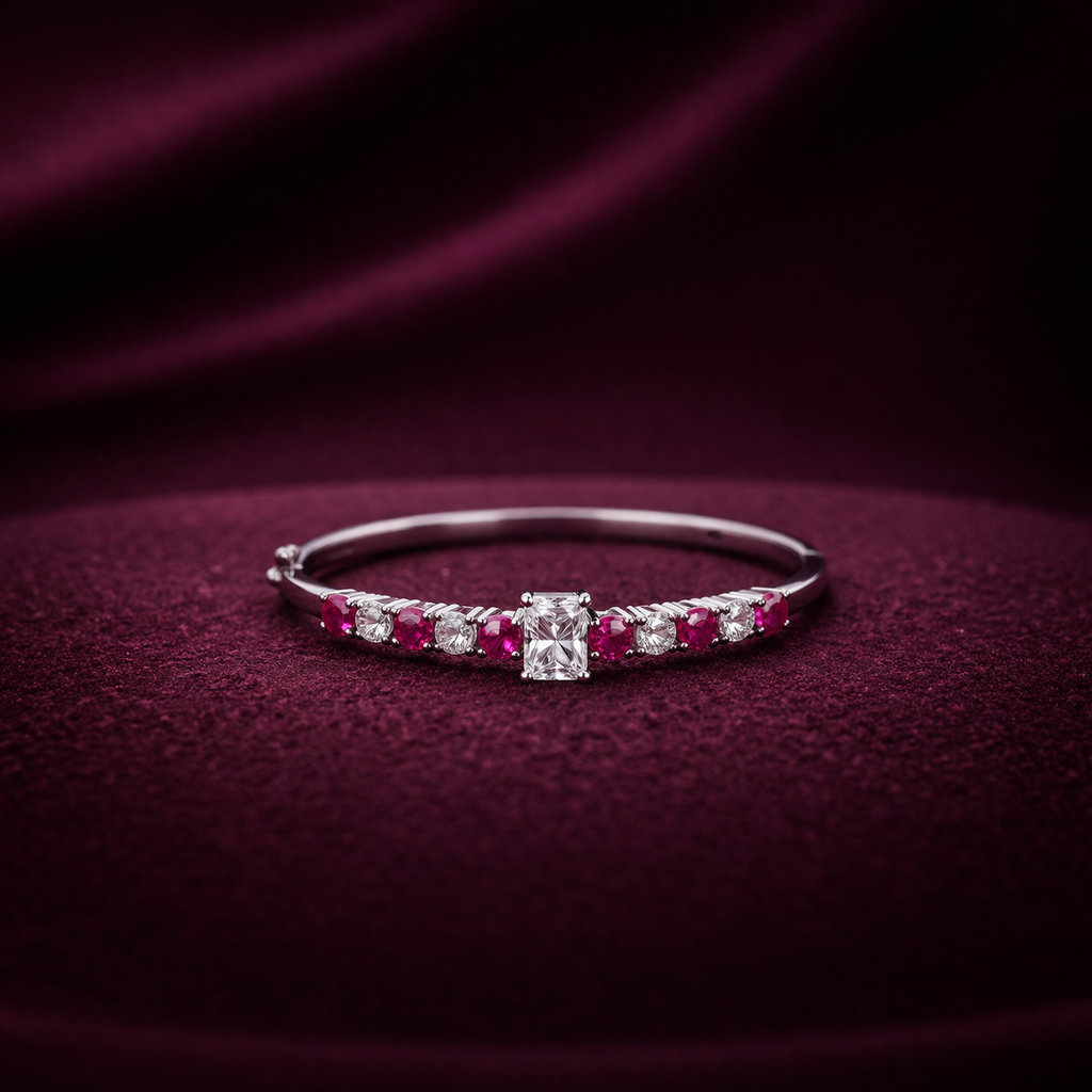 Diamond and ruby bracelet on a dark purple fabric background