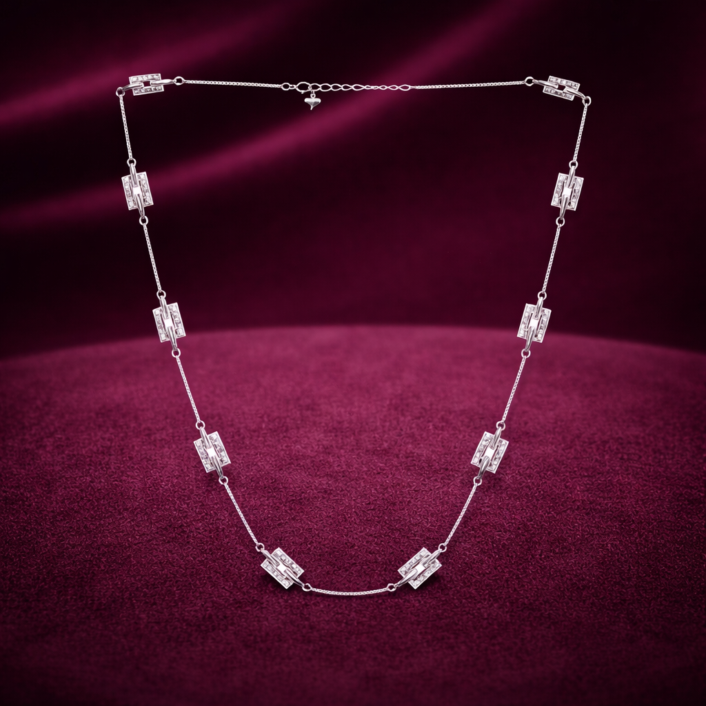 Silver necklace with diamond-like pendants on a purple background