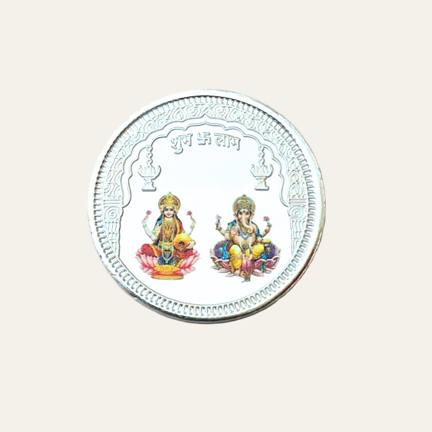 Silver coin with colorful engravings on a white background