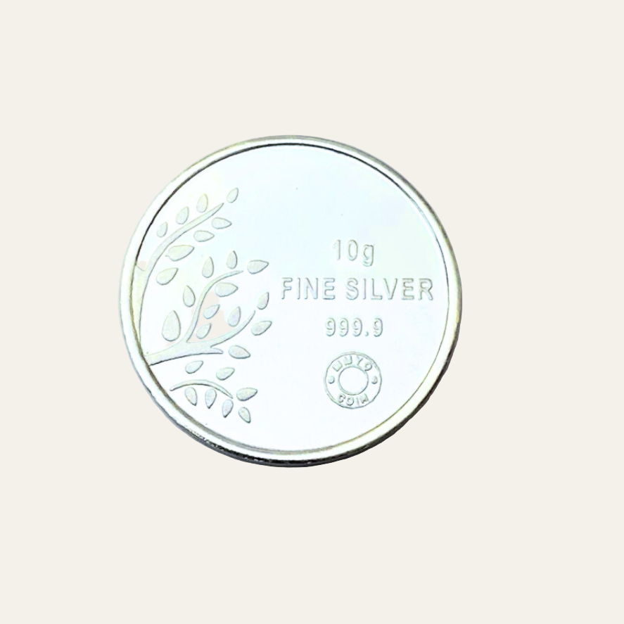 Silver coin with embossed design on a light gray background