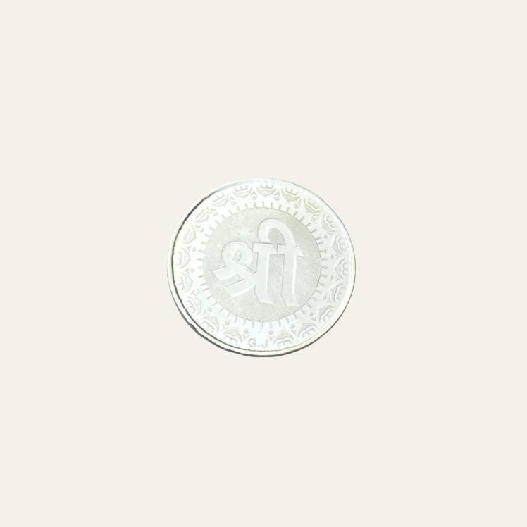 Silver coin with a design on a white background