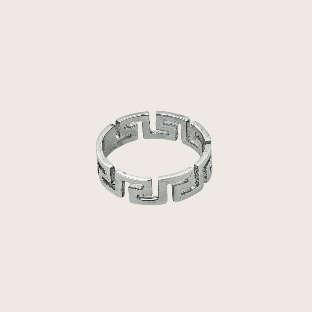 Silver ring with geometric design on a white background, branded 'Trishnna'.