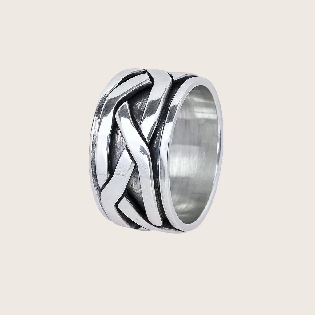 Silver ring with braided design on a white background