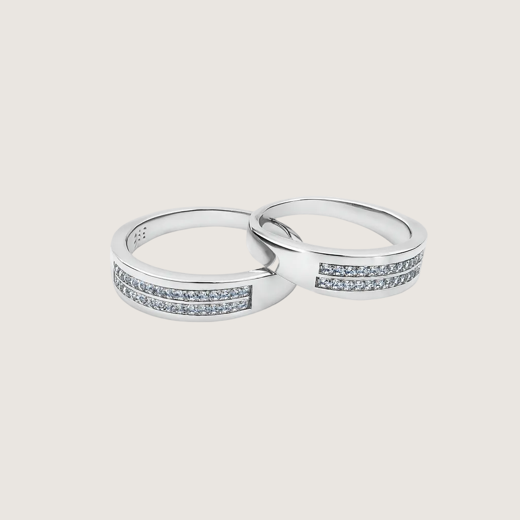 Two silver rings with diamond accents on a white background