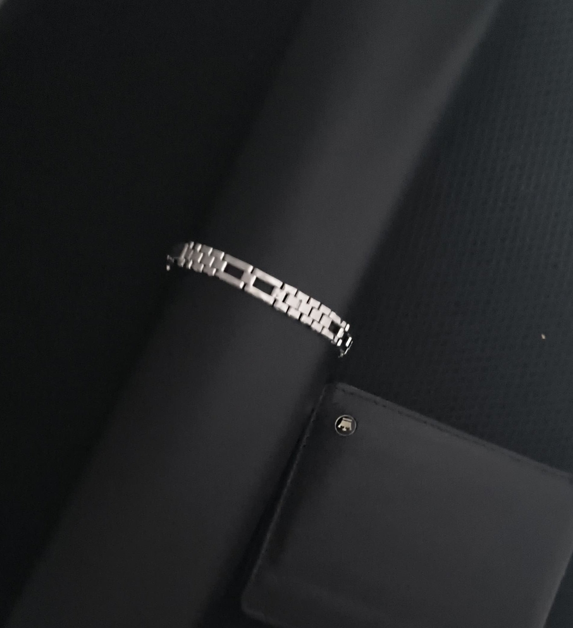 Close-up of a black car seat with a visible brand logo on a white background