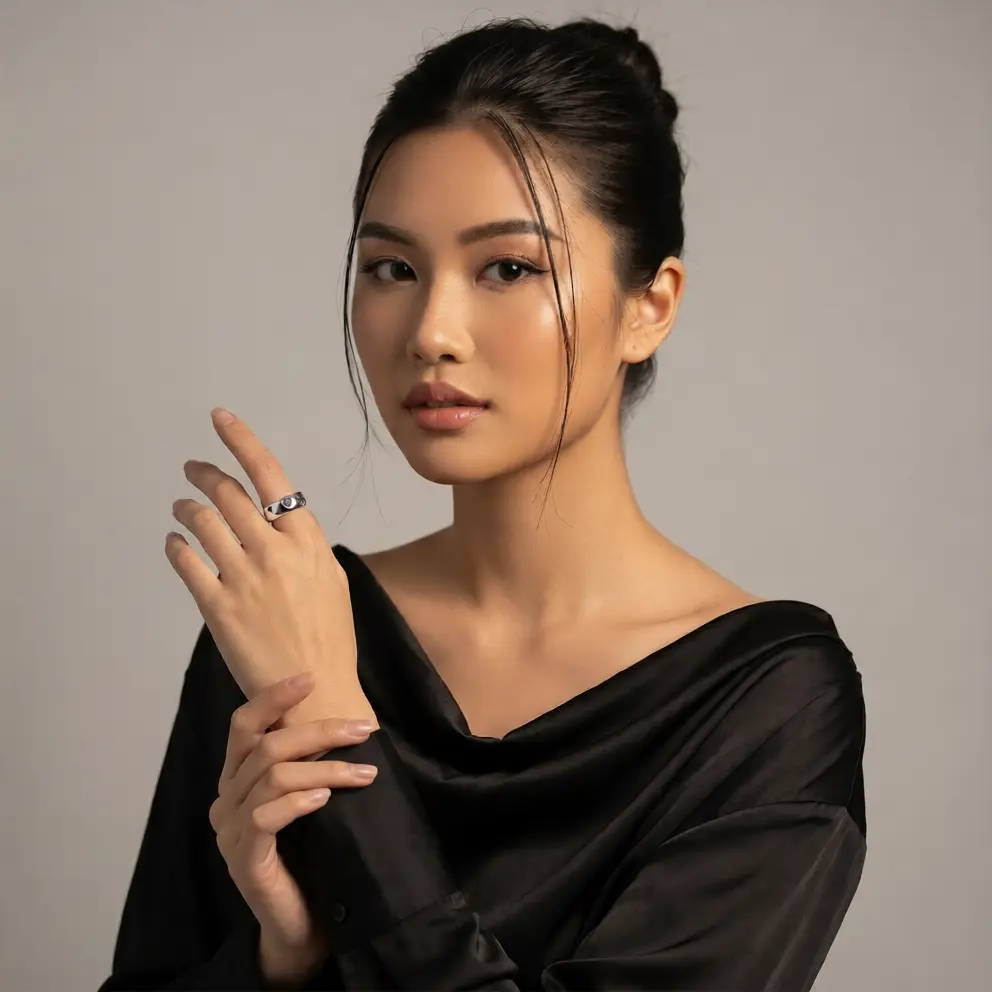 Woman wearing a black outfit with a neutral background